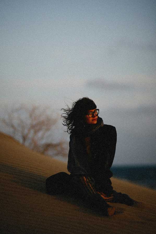 Woman-Sitting-on-Sand